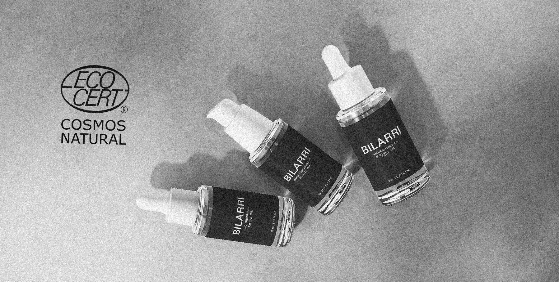 Three Bilarri dropper bottles on a gray background with 'Cosmos Naturals' branding.
