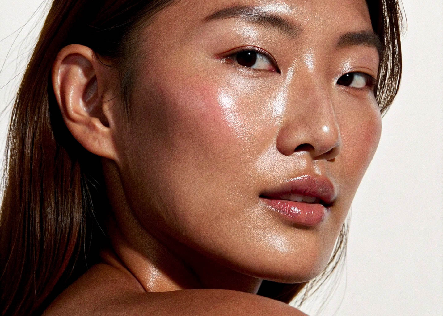 Close-up of a woman's face with a soft focus on her skin texture.