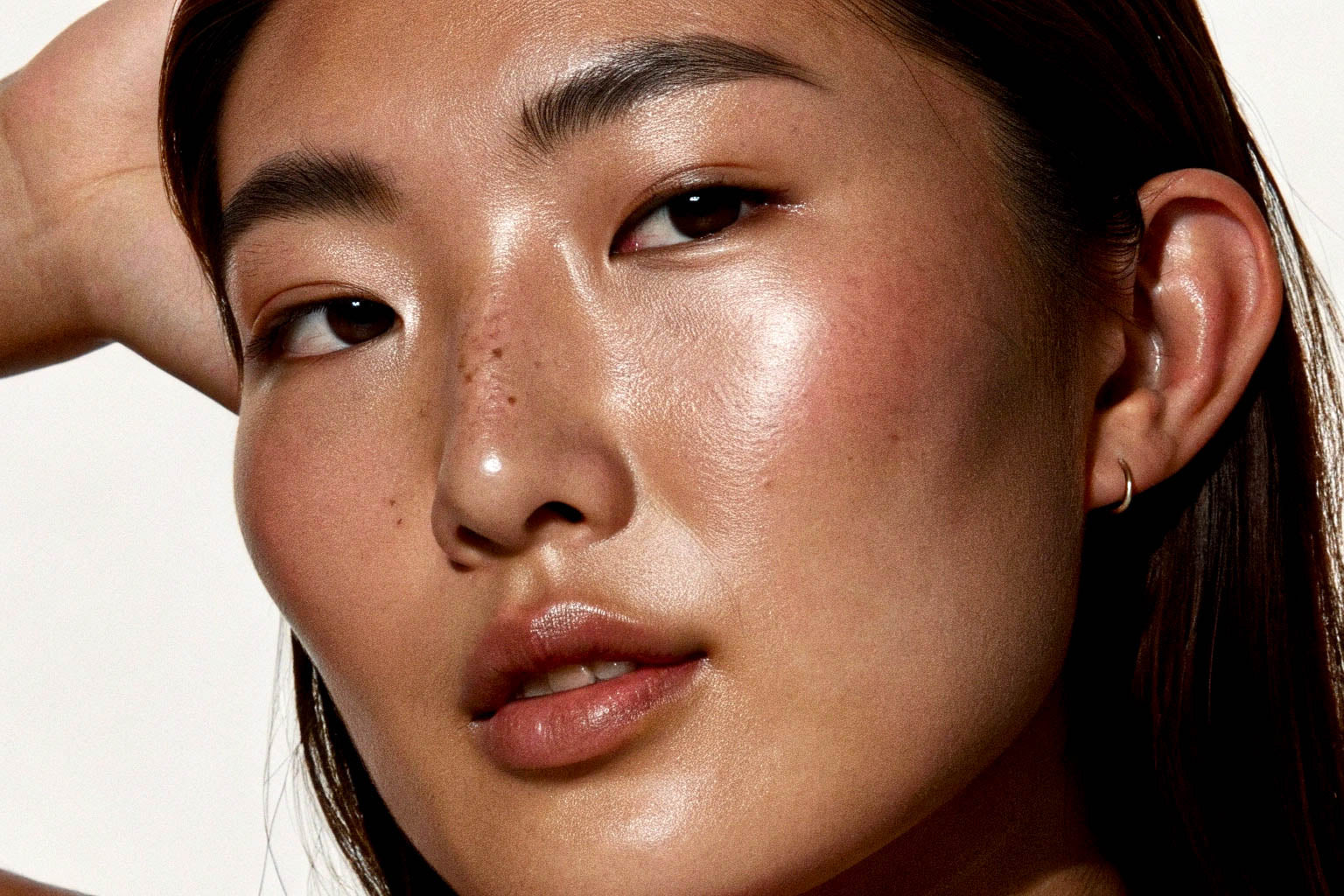 Close-up of a person with a soft focus on the face against a neutral background