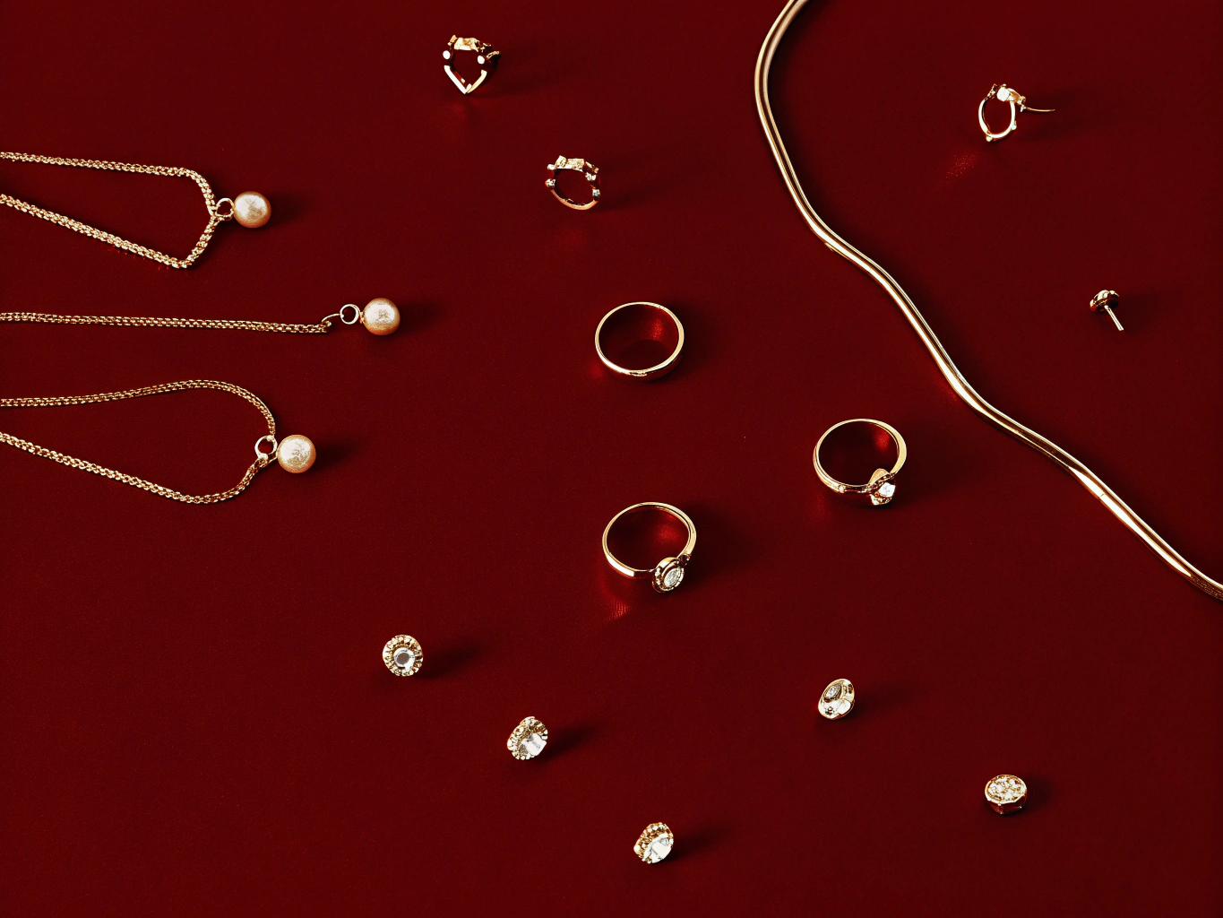 Gold jewelry including necklaces, rings, and earrings on a red background 1. 18k gold plated jewelry
2. gold plated stainless steel jewelry
3. affordable gold jewelry
4. tarnish free gold jewelry
5. waterproof gold jewelry
6. non-tarnish jewelry
7. hypoallergenic gold jewelry
8. everyday gold jewelry
9. durable gold plated jewelry
10. fashion gold jewelry for women
Niche & Long-Tail Keywords (Targeted & Conversion-Focused)
1. 18k gold plated stainless steel necklace
2. water-resistant gold pl