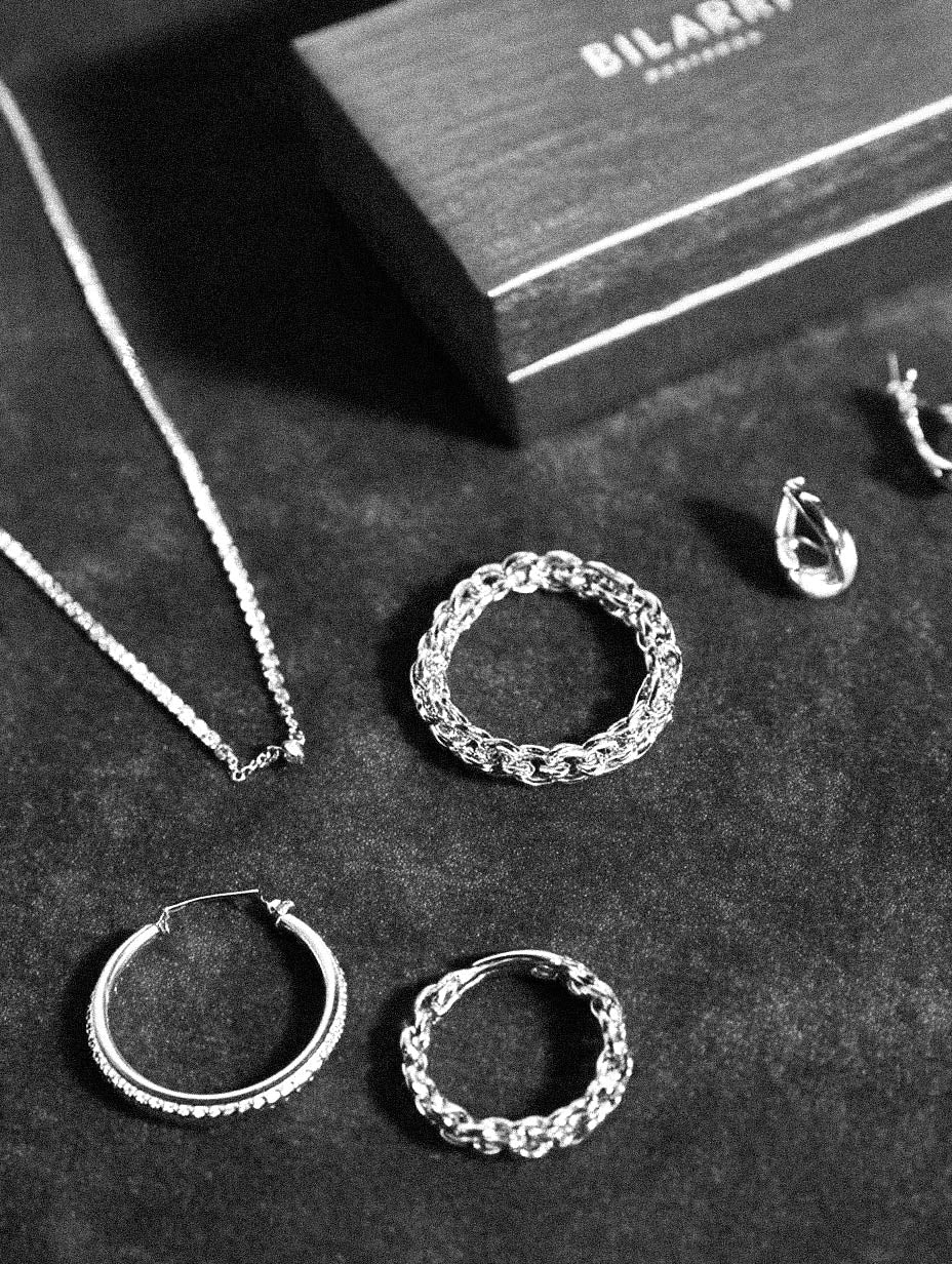 Silver jewelry including rings and a necklace on a dark surface with 'BILARRA' branding. 1. 18k gold plated jewelry
2. gold plated stainless steel jewelry
3. tarnish free gold jewelry
4. waterproof gold jewelry
5. affordable gold jewelry
6. non-tarnish gold jewelry
7. hypoallergenic gold jewelry
8. durable gold plated jewelry
9. everyday gold jewelry
10. buy 18k gold plated jewelry online
11. luxury gold plated jewelry on a budget
12. vegan-friendly gold jewelry
13. minimalist gold plated earrin