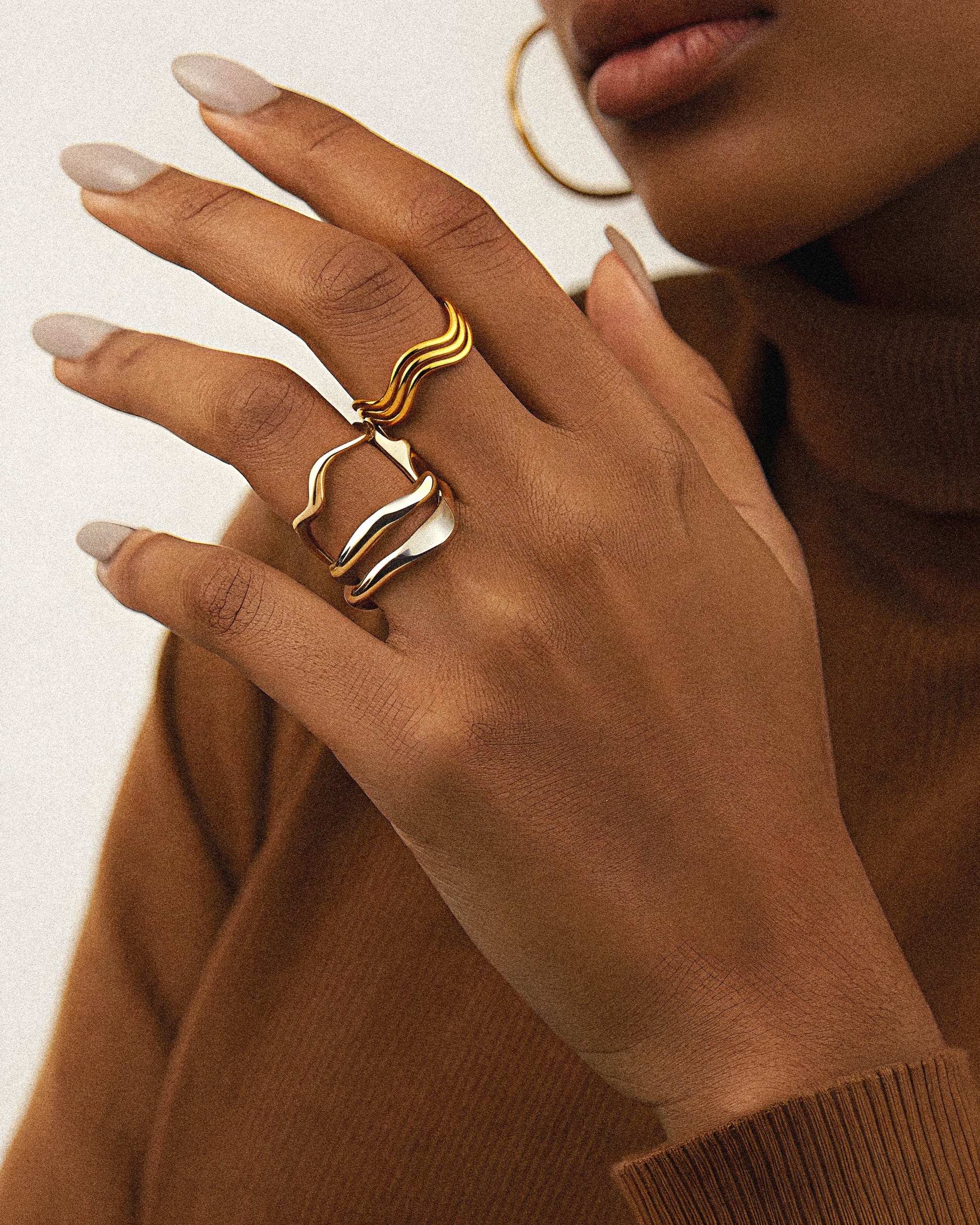 The Seravyn Ring is where elegance meets strength. With its fluid curves and radiant finish, this minimalist ring is designed to reflect inner confidence and effortless style.&nbsp;Perfect as a statement piece or a meaningful gift, Seravyn is more than jewelry, and it’s a symbol of presence and power. Crafted for those who let their light speak for them. on a woman
