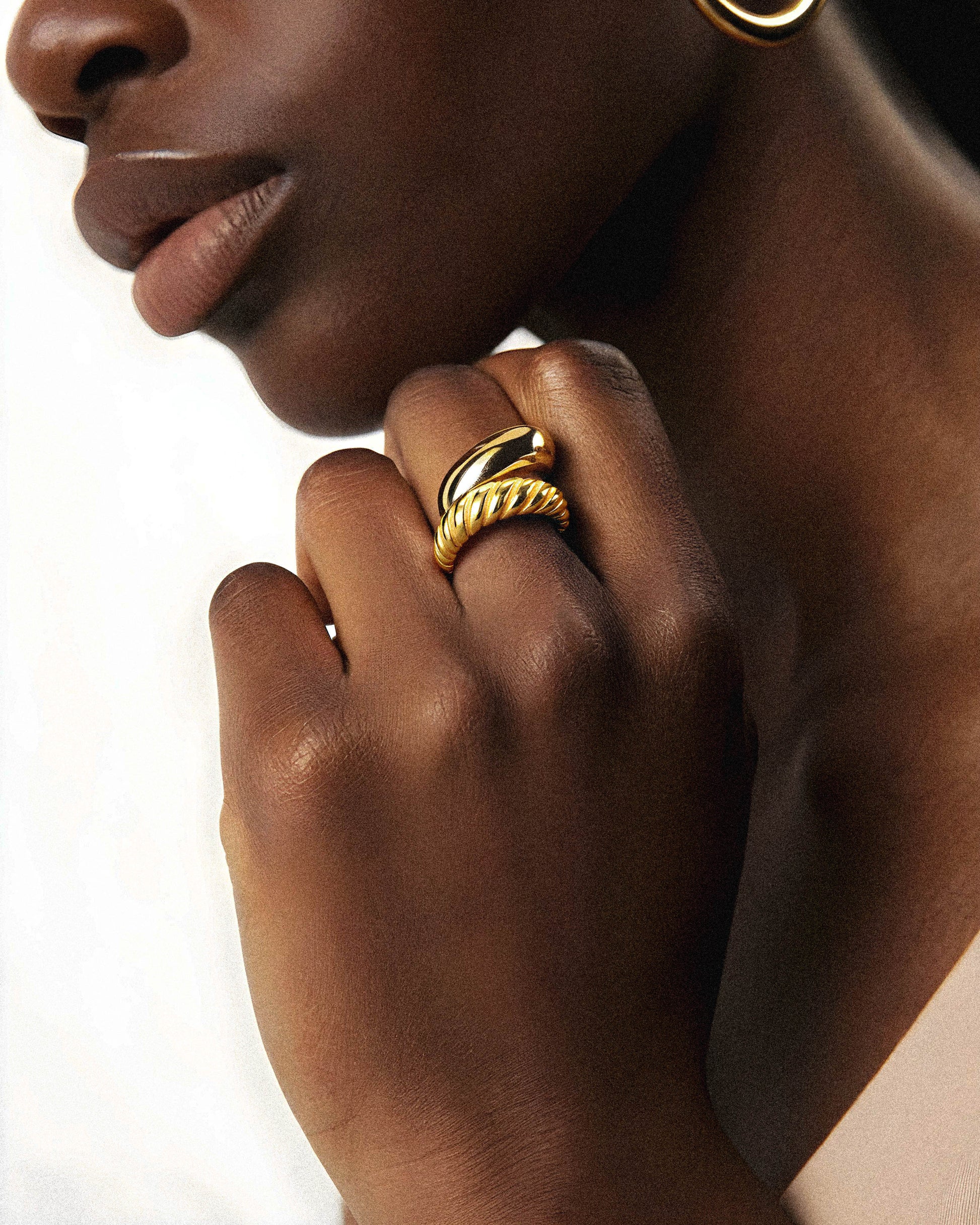 The Cinderlace Ring features a sophisticated gold twist design, perfect for elevating any fashion ensemble. Crafted to combine elegance with contemporary style, this ring adds a refined touch to your look, making it an ideal accessory for both everyday wear and special occasions. Its unique twisted form highlights expert craftsmanship.

