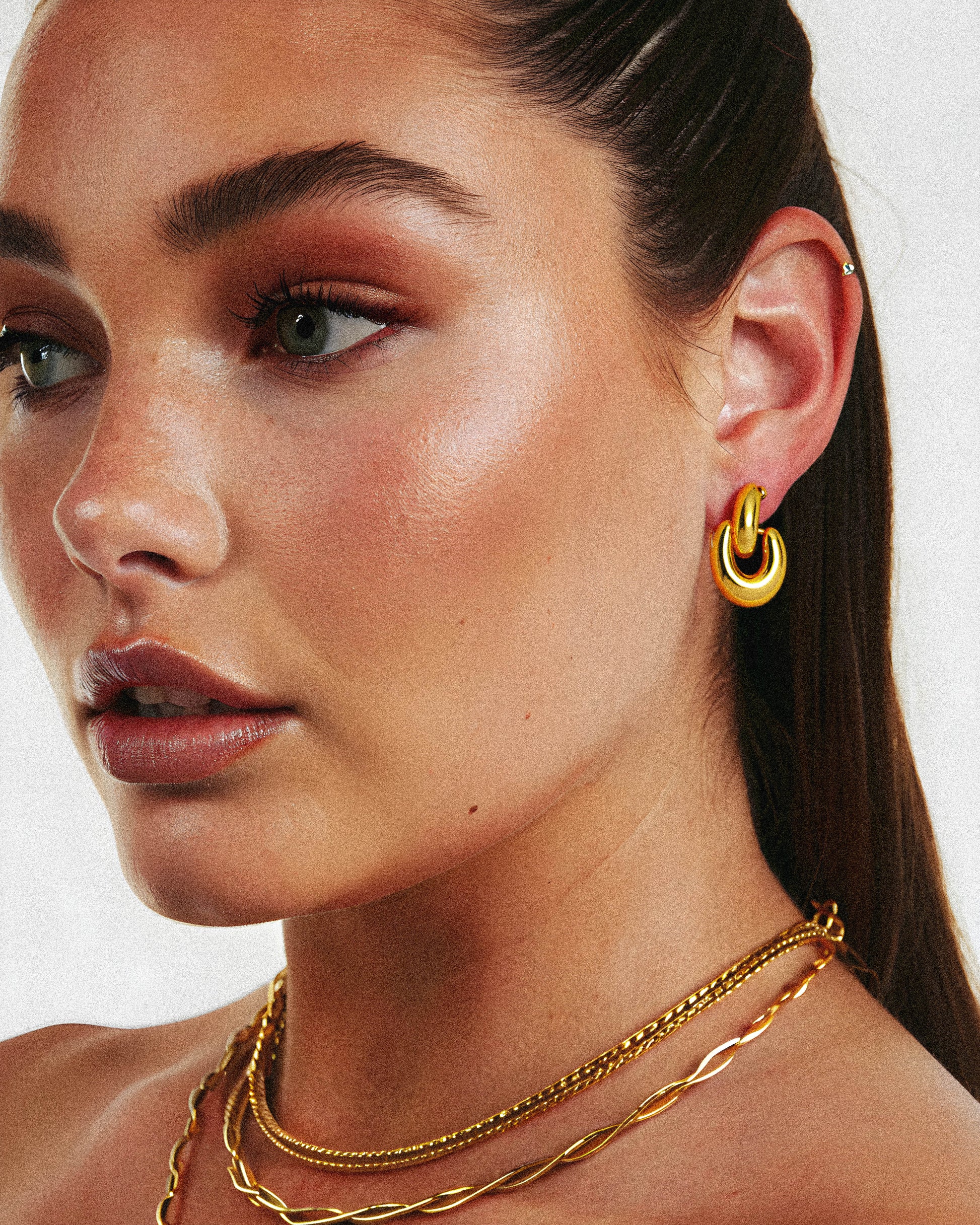 Crafted from solid gold, the Sparkle Earring is offered with a refined finish. Its durable material ensures lasting wear, making it a sophisticated choice for both everyday and special occasions. This earring combines classic design with expert craftsmanship, delivering subtle brilliance that enhances any ensemble. on a woman. 1.	18k gold plated jewelry
	2.	gold plated stainless steel jewelry
	3.	tarnish free gold jewelry
	4.	waterproof gold jewelry
	5.	affordable gold jewelry
	6.	non-tarnish gold jewelry
	